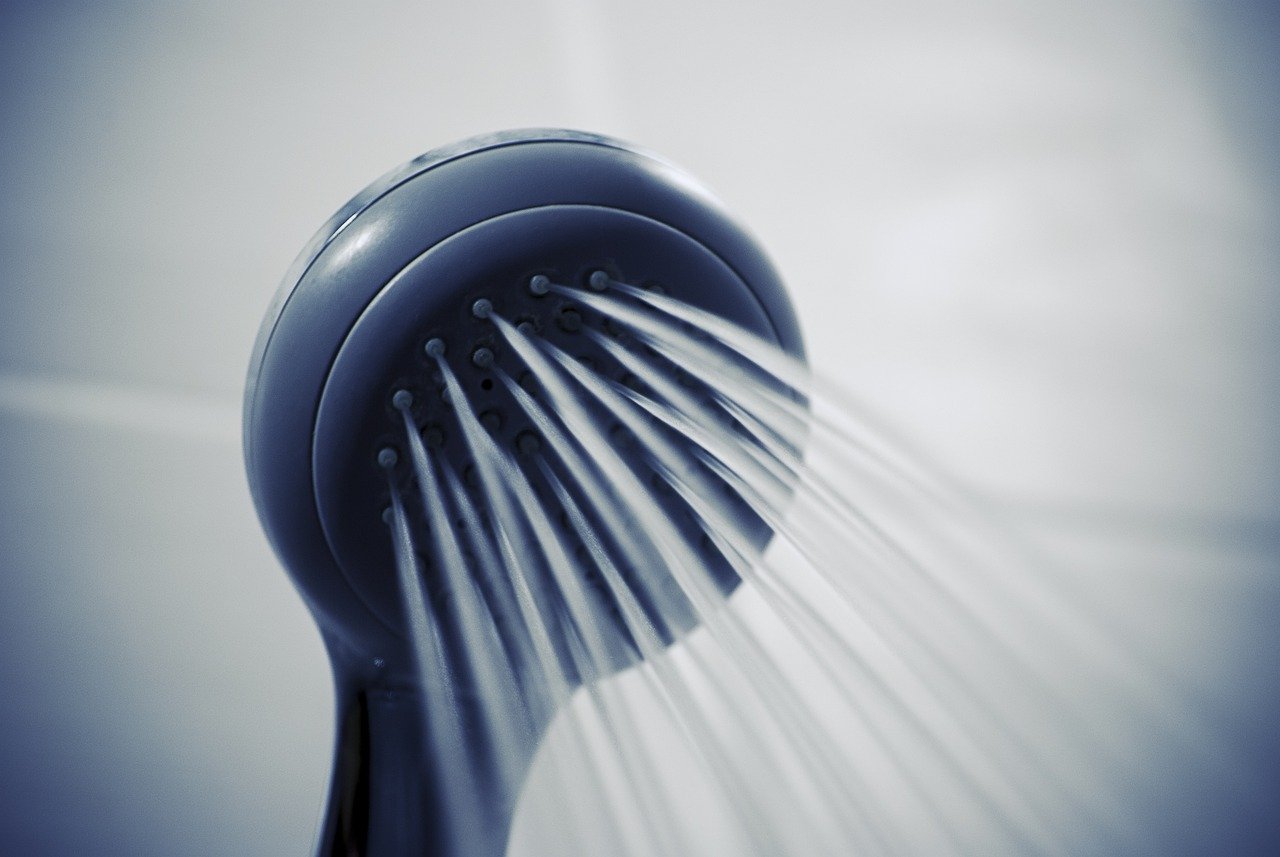 A black showerhead spraying water