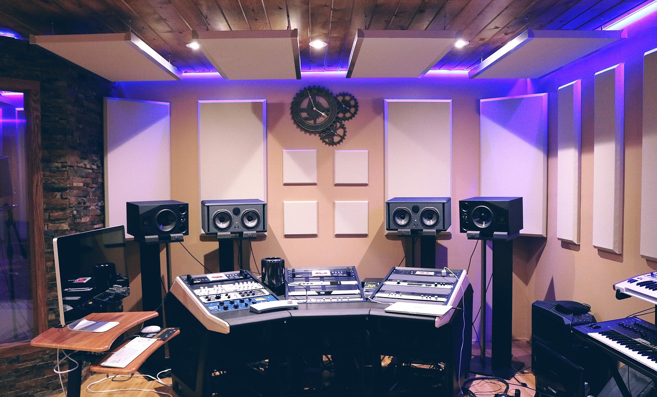A music studio with speakers and a mixing board.